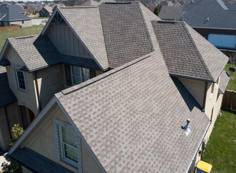 Iowa roofer evaluating repair vs replacement on a damaged roof